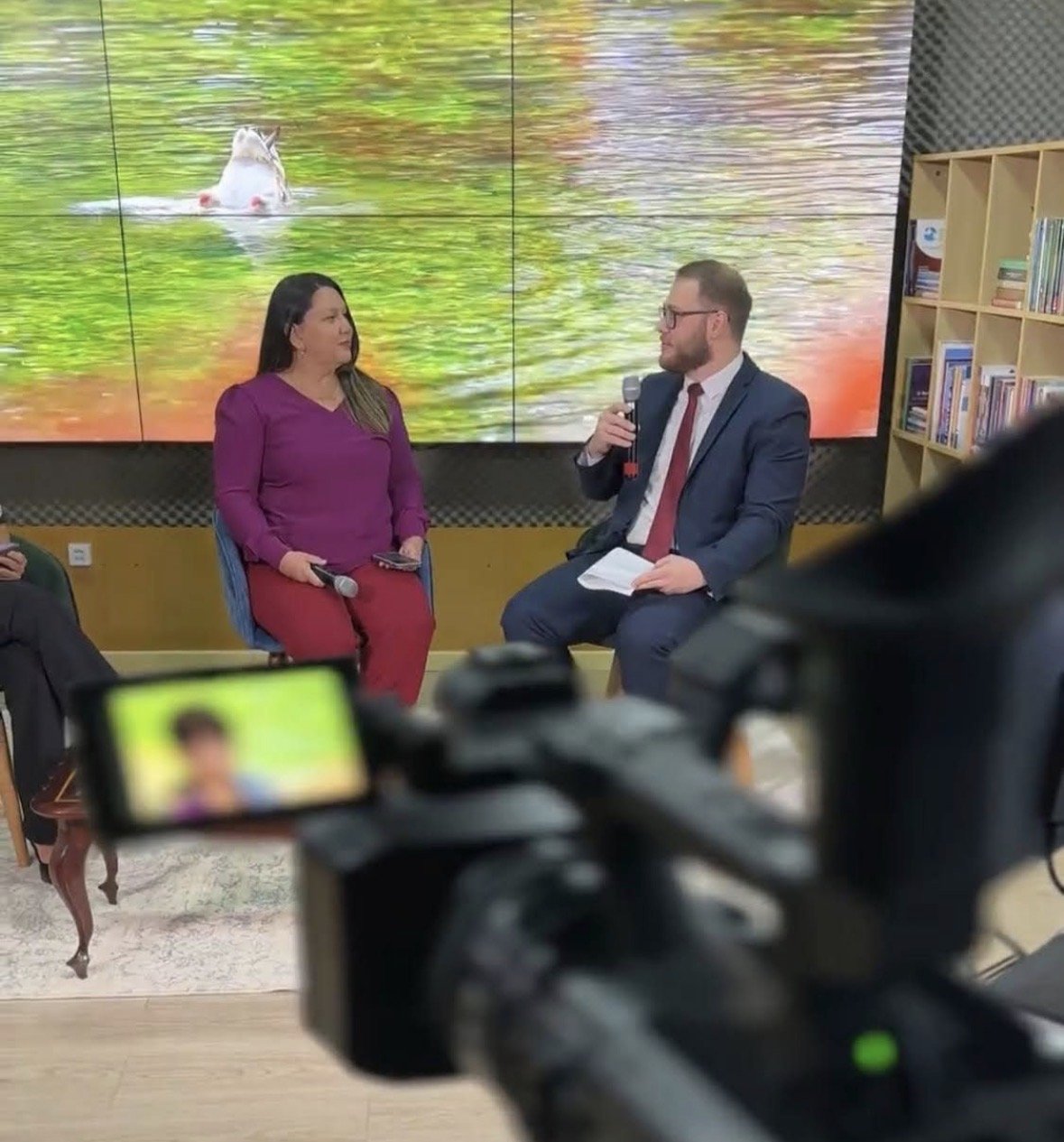 Claudio Klaus holding a microphone during an on-camera interview in Roraima